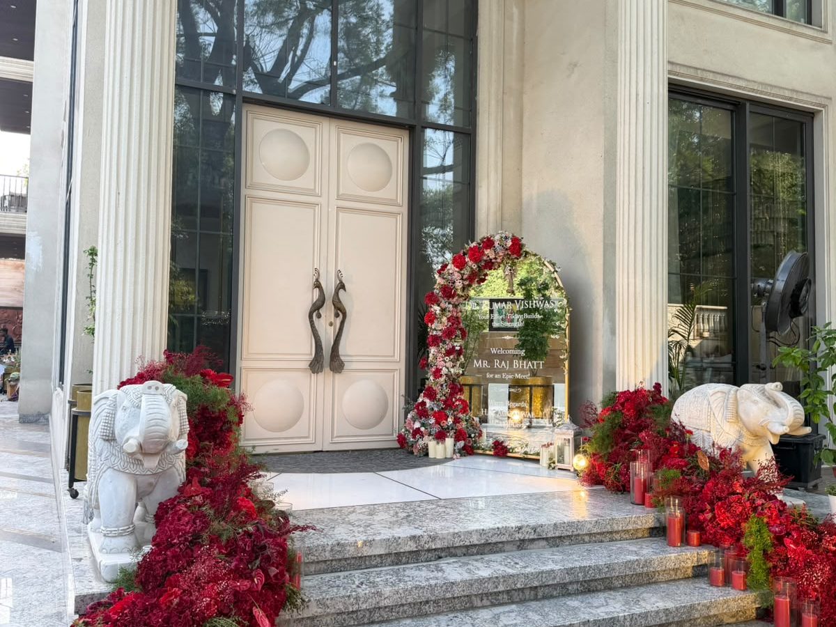 Grand entrance with marble elephants and cascades of red florals and candles
